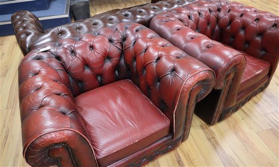 Two leather oxblood leather chesterfield armchairs W.106cm